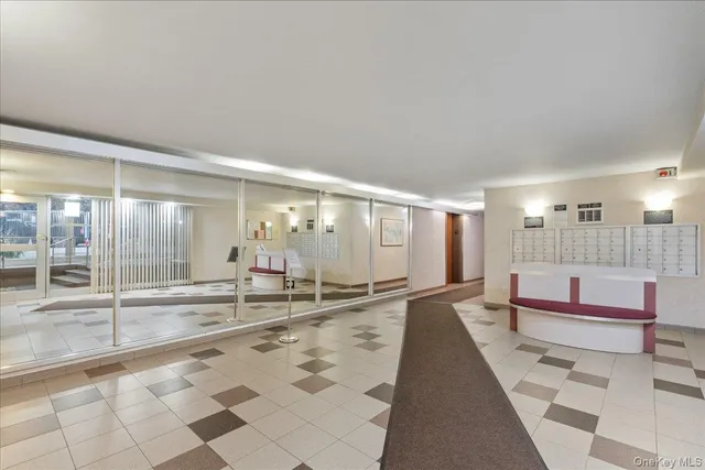 a lobby with furniture and floor to ceiling window