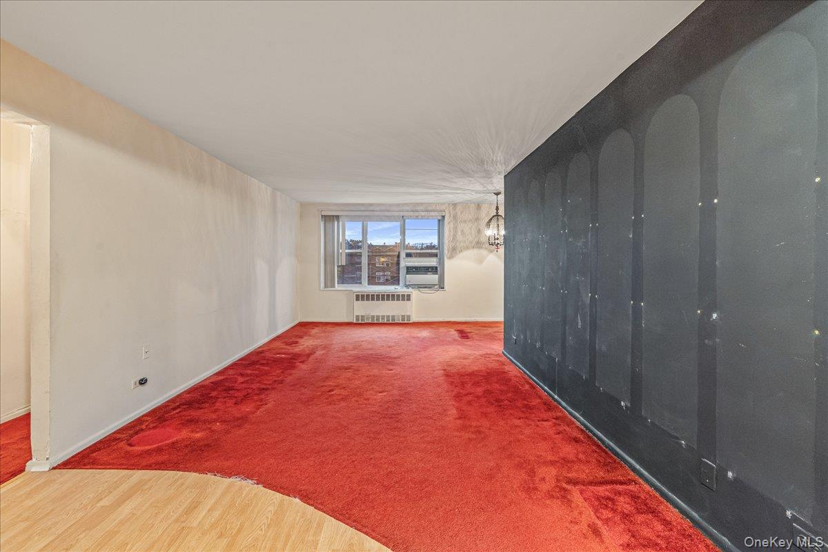 209-25 18th Avenue, Unit 6D Queens, NY 11360 - Photo 5 of 26 a view of an empty room and a window