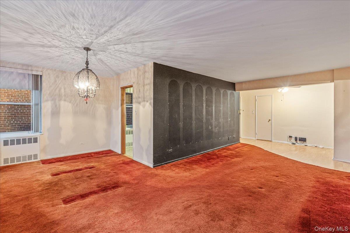 209-25 18th Avenue, Unit 6D Queens, NY 11360 - Photo 8 of 26 a view of empty room with window and ceiling fan