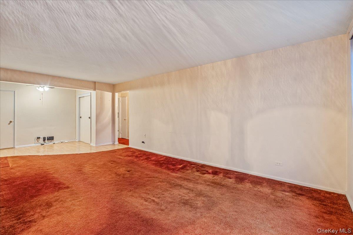 209-25 18th Avenue, Unit 6D Queens, NY 11360 - Photo 9 of 26 a view of an empty room with a window