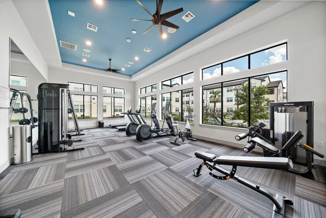 a living room with furniture a flat screen tv and a large window