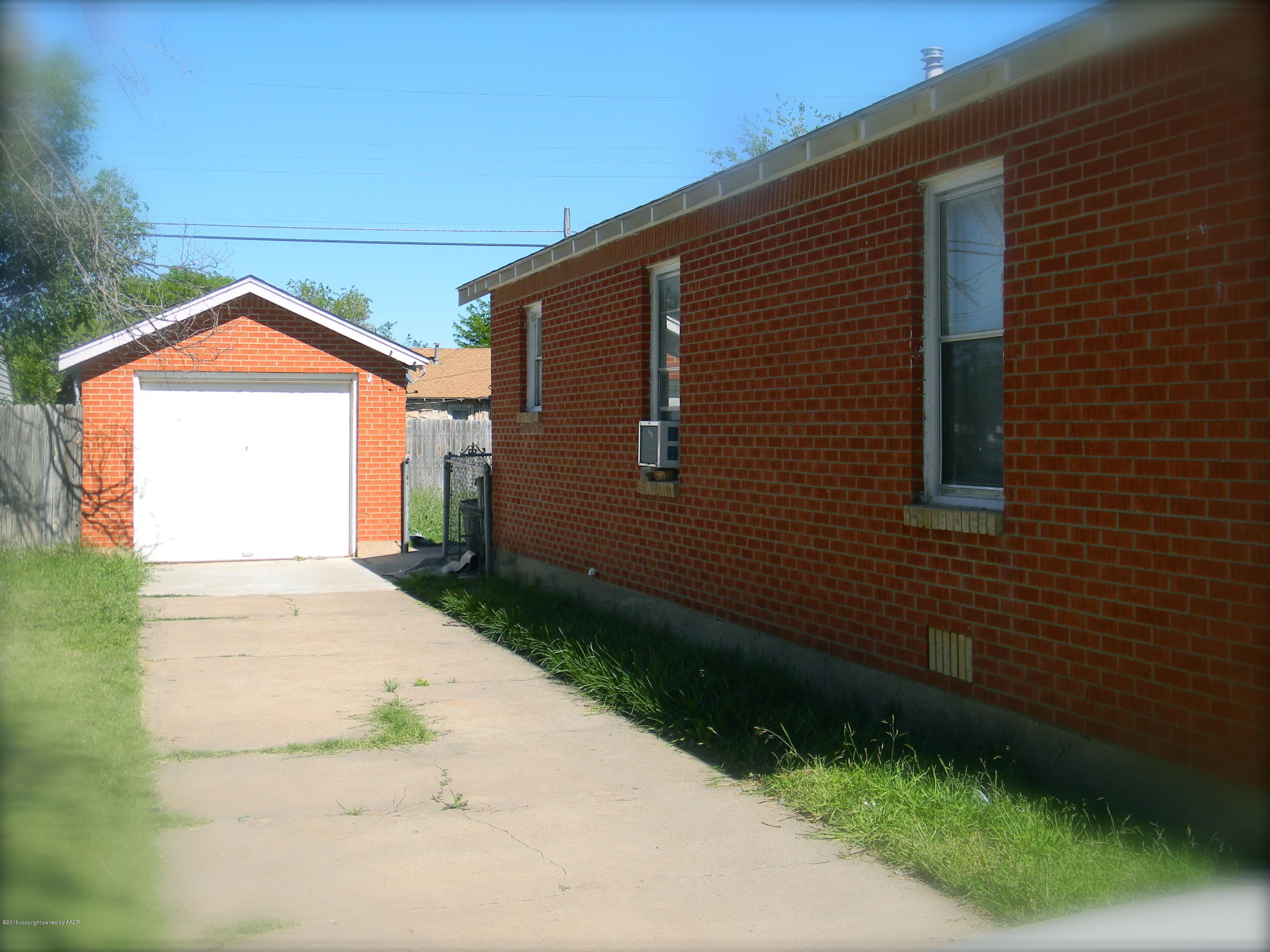 4109 South Jackson Street Amarillo, TX 79110 - Photo 2 of 10 a front view of a house with a yard and garage