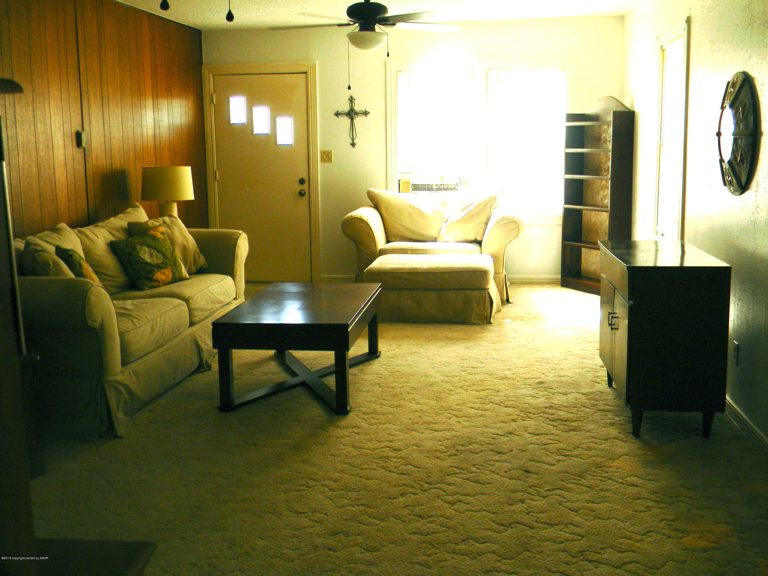 4109 South Jackson Street Amarillo, TX 79110 - Photo 7 of 10 a living room with furniture and a rug