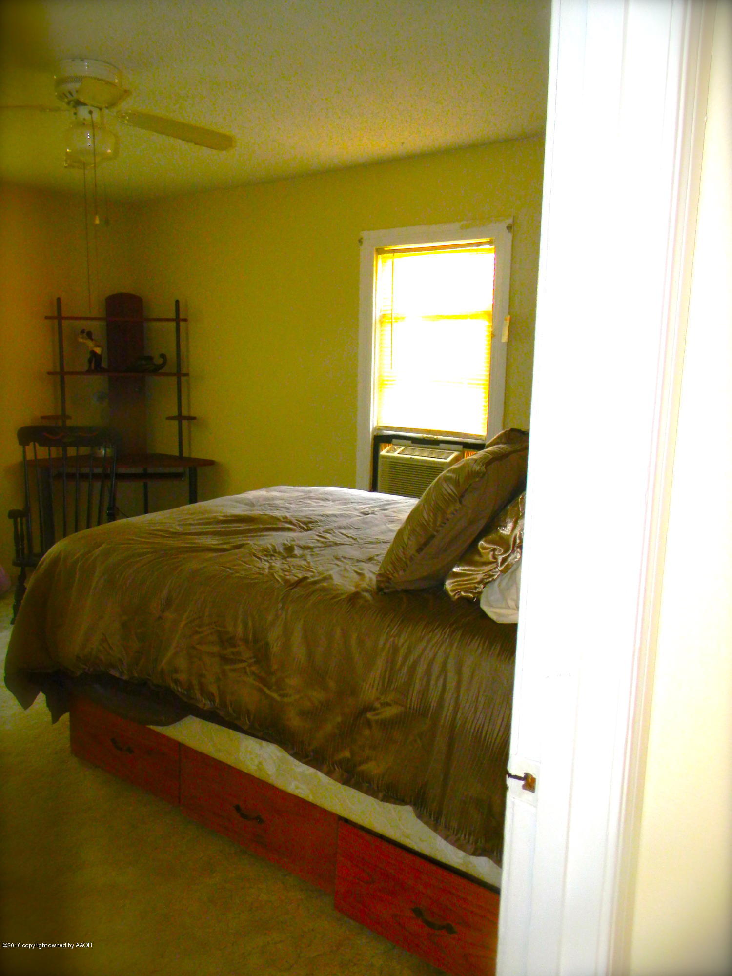 4109 South Jackson Street Amarillo, TX 79110 - Photo 9 of 10 a bed sitting in a bedroom next to a window