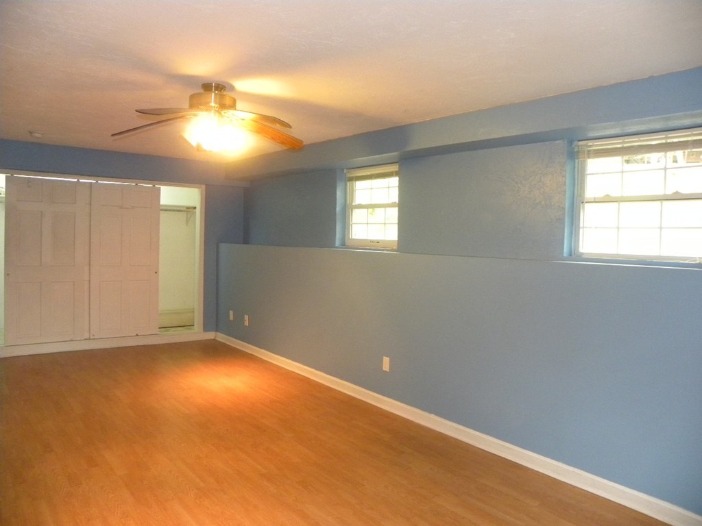 82 Sandersdale Road Charlton, MA 01507 - Photo 16 of 30 an empty room with a window and chandelier fan