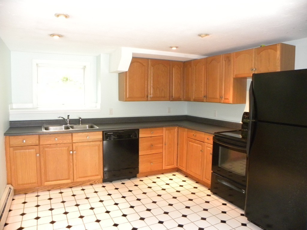 82 Sandersdale Road Charlton, MA 01507 - Photo 4 of 30 a kitchen with granite countertop a refrigerator and a sink