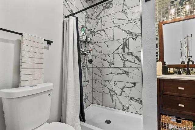 a bathroom with a toilet and shower