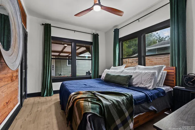 a bedroom with a bed and a large window