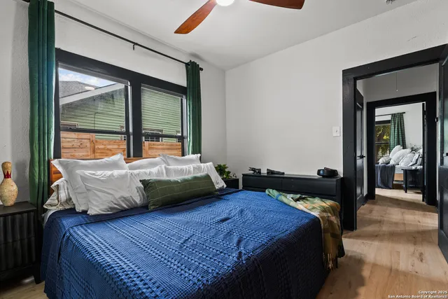 a bedroom with a bed and glass door