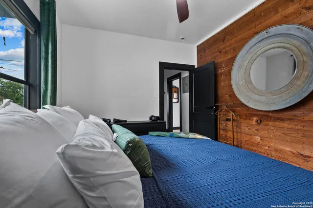 a bed sitting in a bedroom next to a window