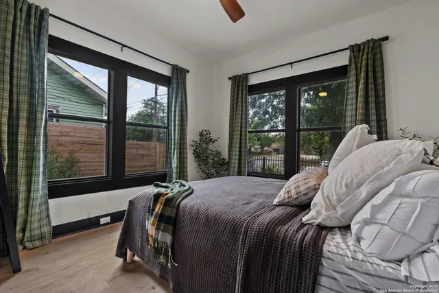 a bed sitting in a bedroom next to a window