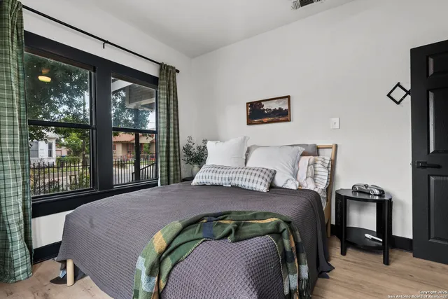 a bedroom with a bed and wooden floor