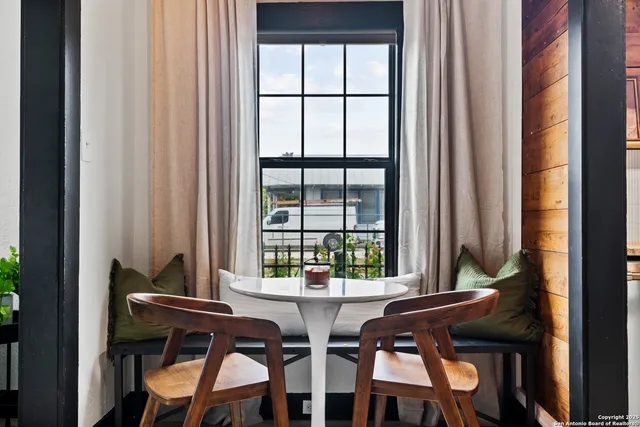 a dining room with furniture and window