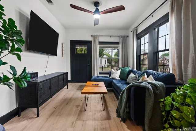 a living room with furniture and a flat screen tv