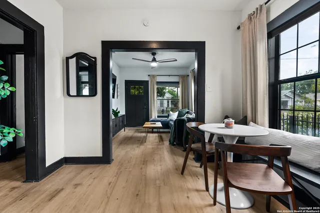 a view of a livingroom with furniture window and wooden floor
