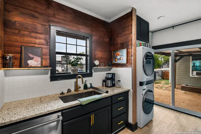 a kitchen with a sink and a stove next to a window