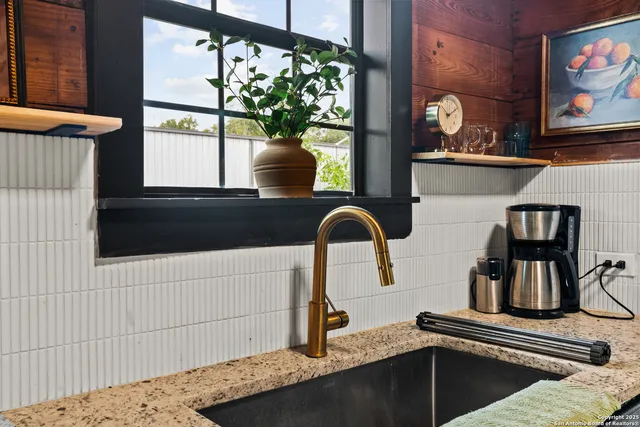 a kitchen with a stove and a window