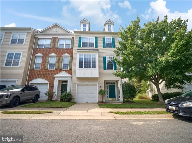 a front view of a residential apartment building with a yard