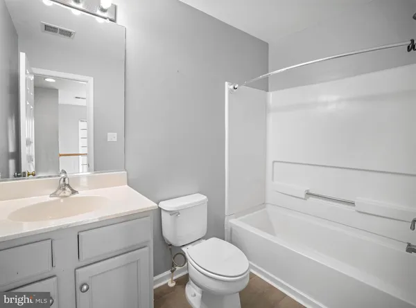 a bathroom with a sink toilet vanity and shower