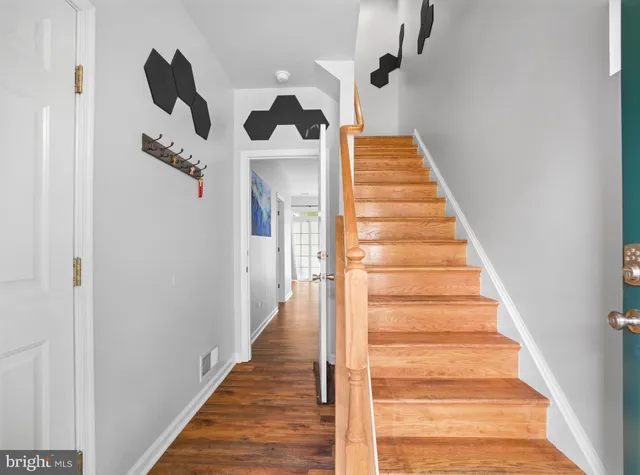 a view of a hallway with wooden floor and entryway