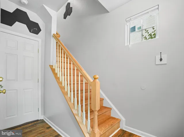 a view of staircase with wooden floor