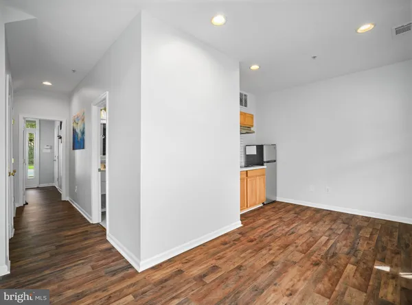 a view of a room with wooden floor and stairs