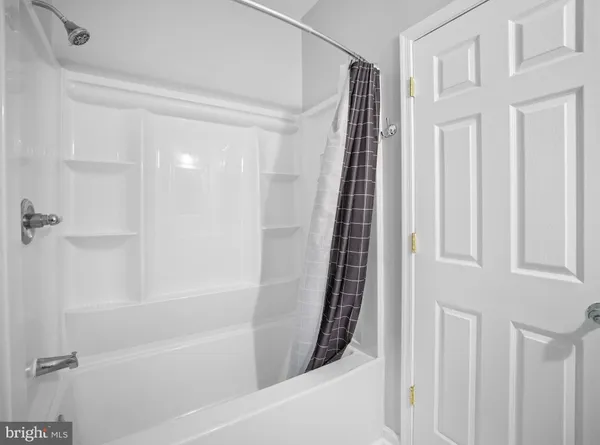 a bathroom with bathtub and shower