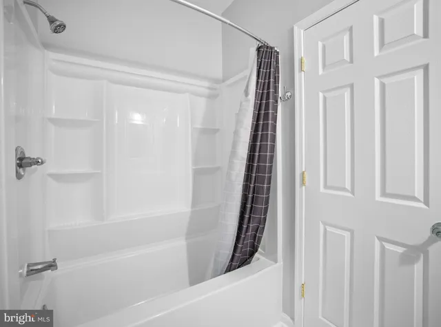 a bathroom with bathtub and shower