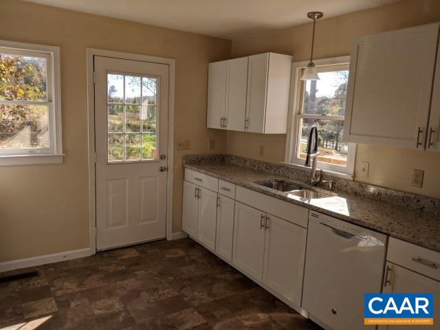 982 Dunnes Shop Road Ruckersville, VA 22968 - Photo 10 of 19 a kitchen with granite countertop a sink window and cabinets