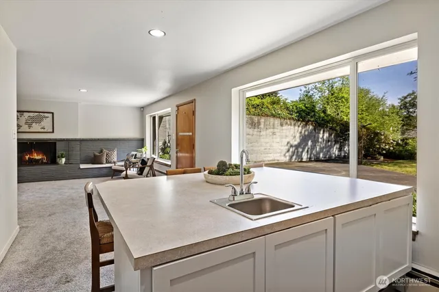 a view of kitchen island a sink and living room view