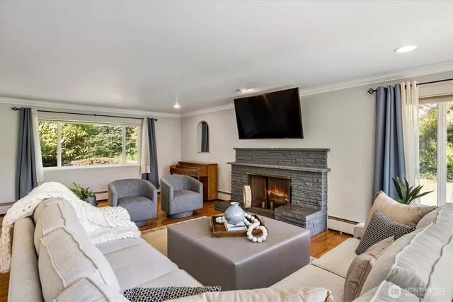 a living room with furniture a fireplace and a flat screen tv