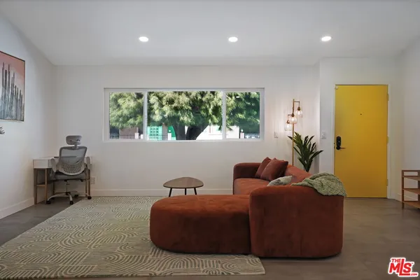 a living room with furniture and a potted plant