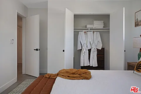 a bedroom with a bed and a closet