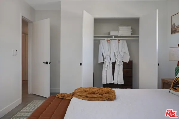 a bedroom with a bed and a closet