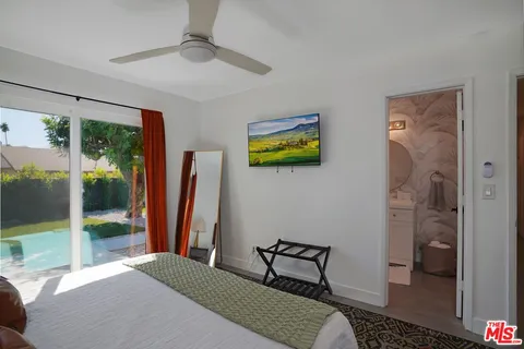 a bedroom with a bed and a view of bathroom