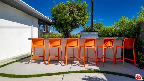 a view of swimming pool with chairs