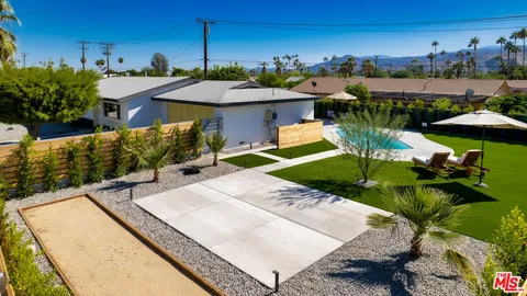 a view of a backyard with sitting area