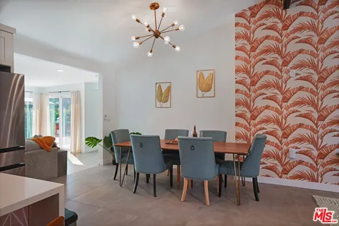 a view of a livingroom with furniture and a floor to ceiling window