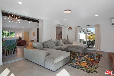 a living room with furniture and a dining table