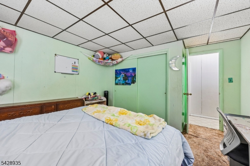 50 Preston Street Ridgefield Park, NJ 07660 - Photo 32 of 41 a bedroom with a bed and a chandelier