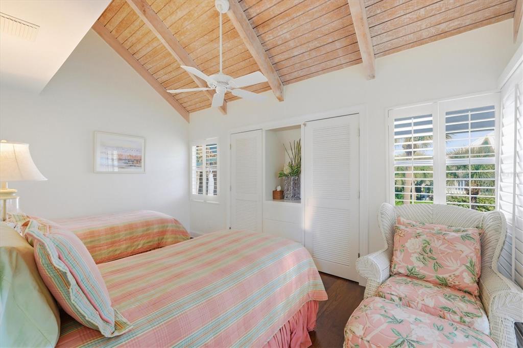 5000 Gasparilla Road, Unit 16 Boca Grande, FL 33921 - Photo 14 of 46 a bedroom with a bed and wooden floor