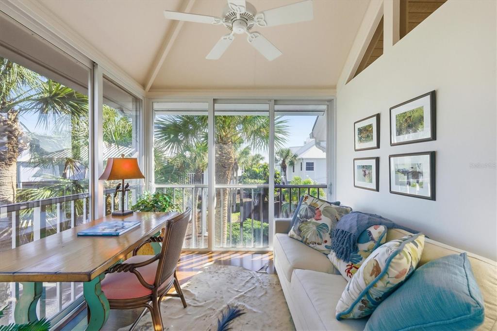 5000 Gasparilla Road, Unit 16 Boca Grande, FL 33921 - Photo 16 of 46 a living room with furniture and a large window