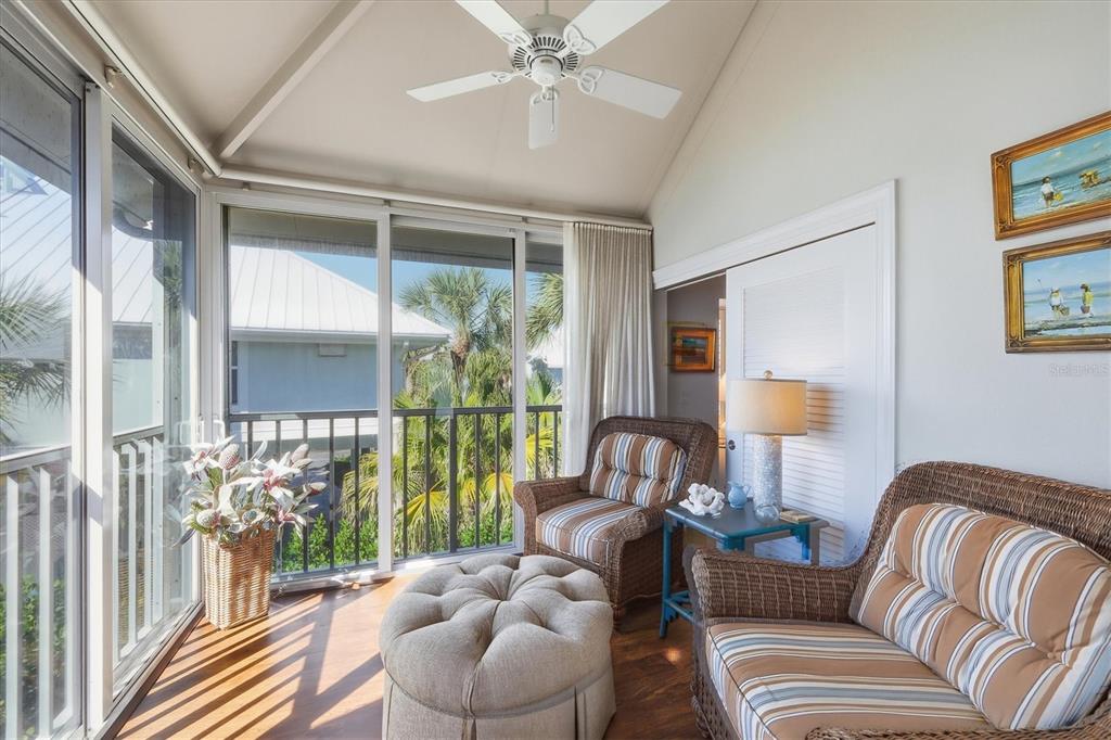 5000 Gasparilla Road, Unit 16 Boca Grande, FL 33921 - Photo 17 of 46 a living room with furniture and a lamp