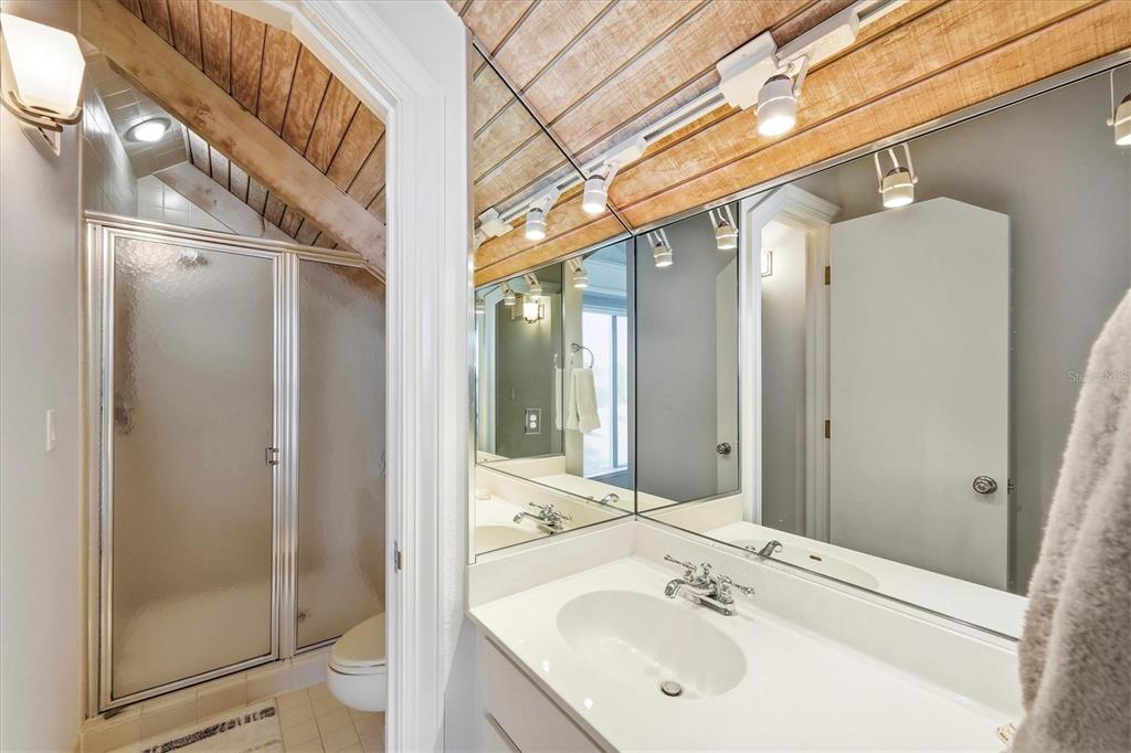 5000 Gasparilla Road, Unit 16 Boca Grande, FL 33921 - Photo 24 of 46 a bathroom with a sink and shower