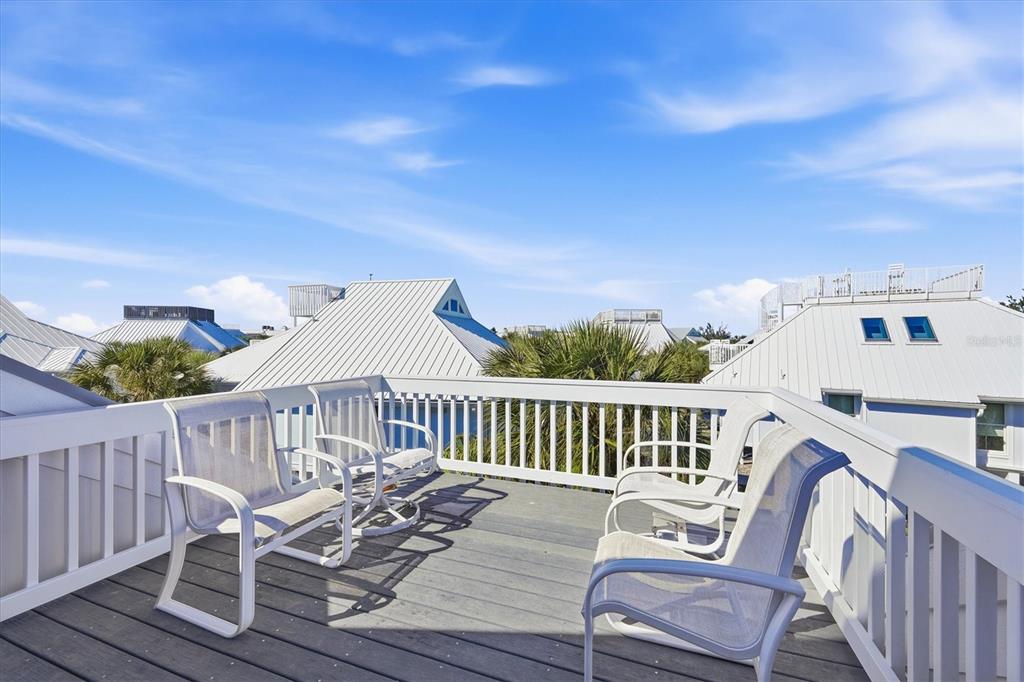 5000 Gasparilla Road, Unit 16 Boca Grande, FL 33921 - Photo 26 of 46 a view of balcony with wooden floor and seating space