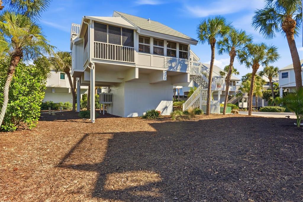5000 Gasparilla Road, Unit 16 Boca Grande, FL 33921 - Photo 28 of 46 a view of a house with a yard and sitting area