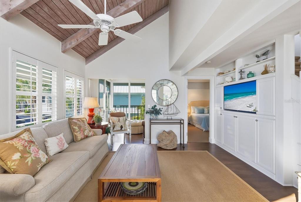 5000 Gasparilla Road, Unit 16 Boca Grande, FL 33921 - Photo 5 of 46 a living room with furniture a fireplace and a window