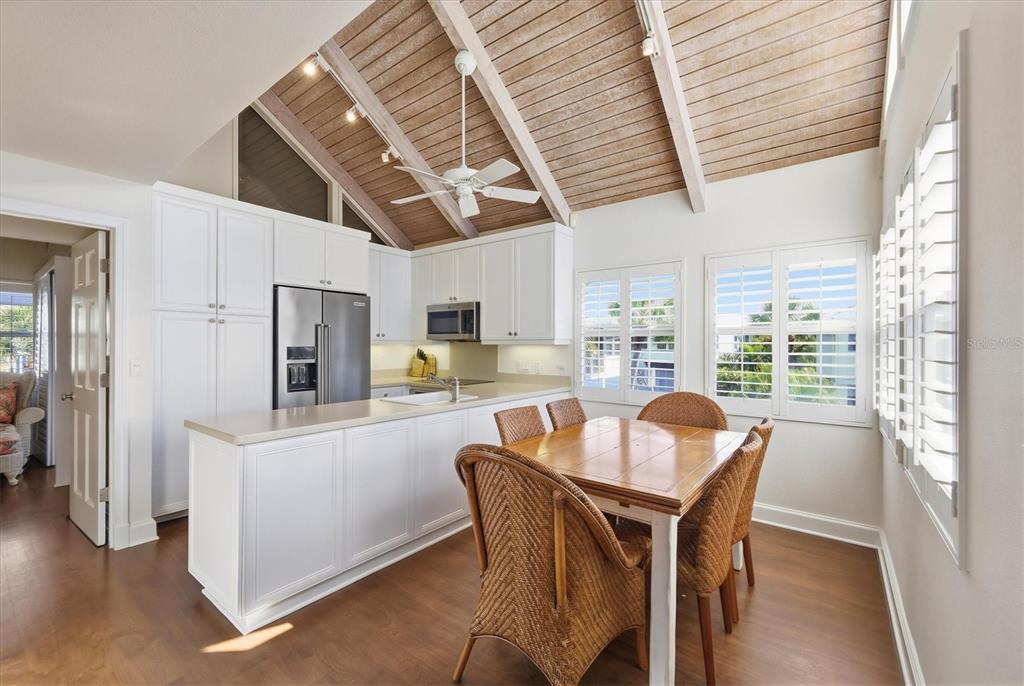 5000 Gasparilla Road, Unit 16 Boca Grande, FL 33921 - Photo 6 of 46 a dining room with stainless steel appliances kitchen island granite countertop furniture and a kitchen view