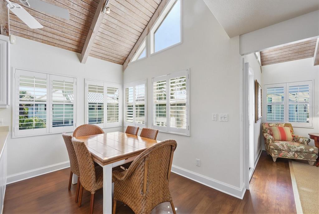 5000 Gasparilla Road, Unit 16 Boca Grande, FL 33921 - Photo 7 of 46 a dining room with furniture and wooden floor