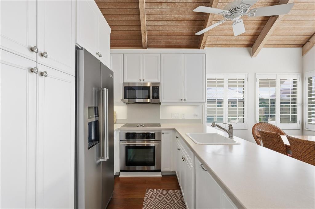 5000 Gasparilla Road, Unit 16 Boca Grande, FL 33921 - Photo 8 of 46 a kitchen with stainless steel appliances granite countertop a sink stove and refrigerator